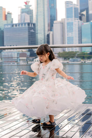 White tutu dress with floral print and puffy sleeves