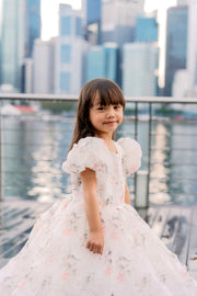 White tutu dress with floral print and puffy sleeves