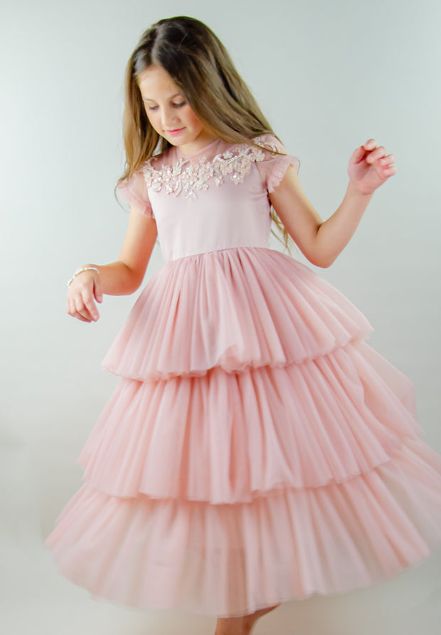 Ankle-length princess dress in a baby pink color with multi-layered tulle skirt, transparent ruffled sleeves and floral embroidery on the front and back satin bodice. Girl dress for special occasions: flower girls, weddings, birthday party, communion, Eid.