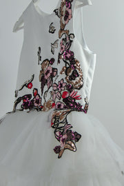 handmade long white flower girl dress with a multi-layered tulle skirt and pink and red floral embroidery