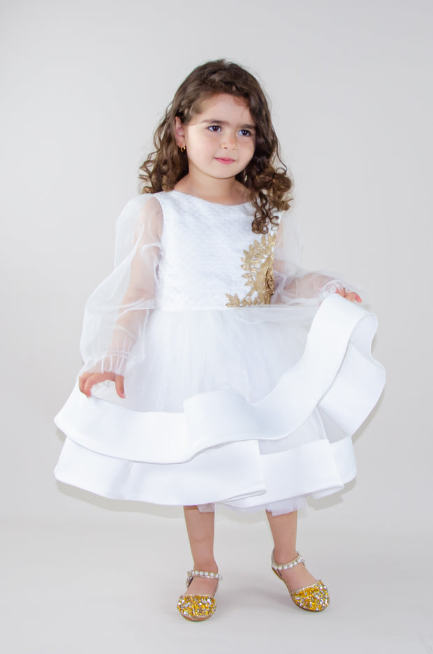 Handmade short white flower girl's dress with a multi-layered tutu skirt, golden embroidery and a big bow on the back