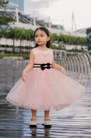 Knee-length apricot tulle dress for girls with a voluminous tulle skirt, black polka dot pattern and two cute ribbons at the waistline. Handmade with love. Occasions: Wedding, Birthday party, Prom, Flower girl, Eid, and other events.