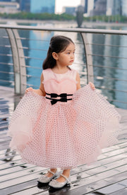 Knee-length apricot tulle dress for girls with a voluminous tulle skirt, black polka dot pattern and two cute ribbons at the waistline. Handmade with love. Occasions: Wedding, Birthday party, Prom, Flower girl, Eid, and other events.