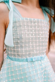 Elegant, a-line girls' dress in a beautiful aquamarine color, featuring a peplum style top embroidered with pearls and decorated with a belt and ribbons. Handmade with love. Occasions: Wedding, Birthday party, Prom, Flower girl, Eid, and other events.