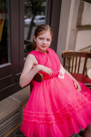 Bright pink festive girl dress. The top is made of bright pink pleated tulle. The bottom is a skirt made of multi-layered tulle with ruffle endings. The waistline is defined by a white glittery bow. Handmade with love. Occasions: Wedding, Birthday party, Flower girl, Communion, Christmas, New Year, and other events.