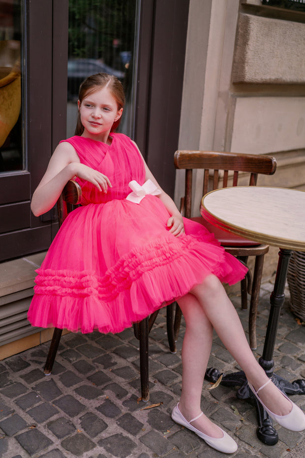 Bright pink festive girl dress. The top is made of bright pink pleated tulle. The bottom is a skirt made of multi-layered tulle with ruffle endings. The waistline is defined by a white glittery bow. Handmade with love. Occasions: Wedding, Birthday party, Flower girl, Communion, Christmas, New Year, and other events.