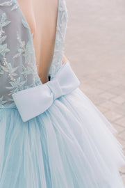 Girls' elegant tulle dress in dusty blue in a high-low hemline style. Tulle skirt, long tulle train, embroidered top and open back create an elegant, modern princess look. Handmade with love. Occasions: Wedding, Birthday party, Prom, Flower girl, Eid, and other events.