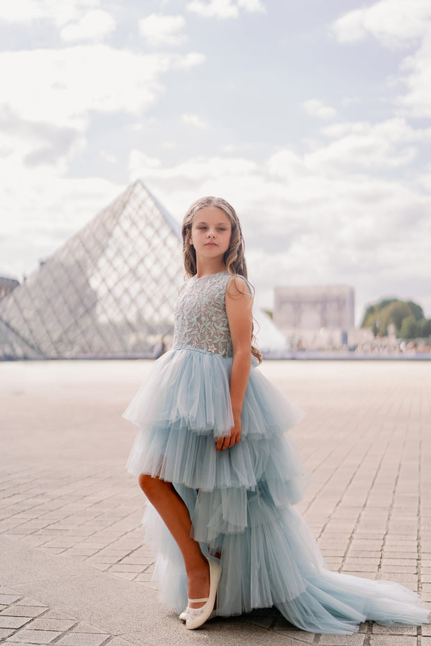 Girls' elegant tulle dress in dusty blue in a high-low hemline style. Tulle skirt, long tulle train, embroidered top and open back create an elegant, modern princess look. Handmade with love. Occasions: Wedding, Birthday party, Prom, Flower girl, Eid, and other events.