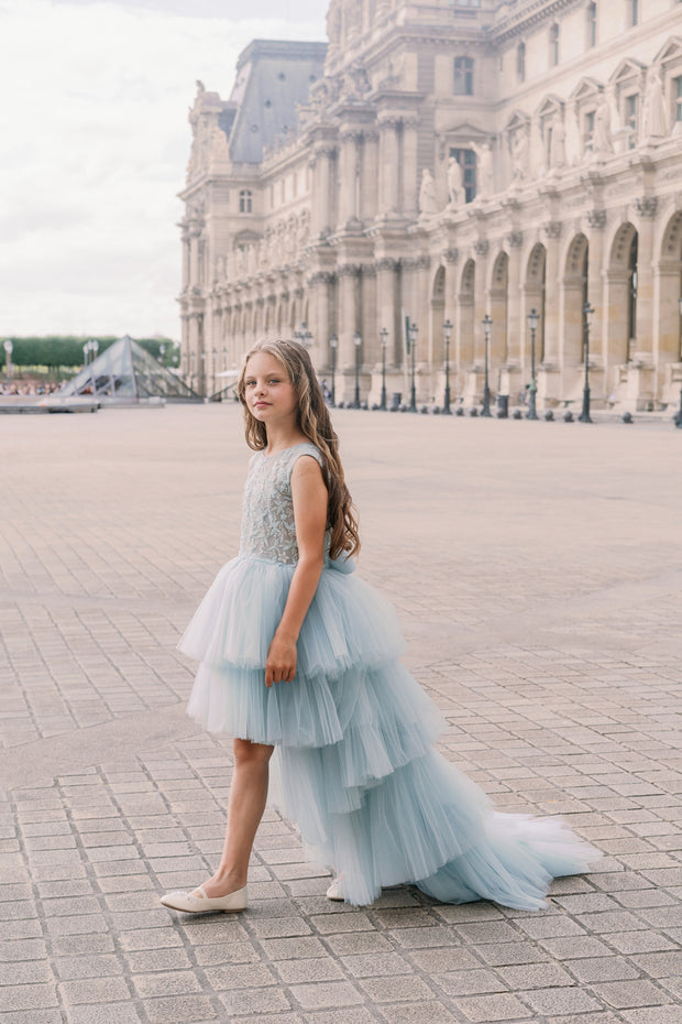 Girls' elegant tulle dress in dusty blue in a high-low hemline style. Tulle skirt, long tulle train, embroidered top and open back create an elegant, modern princess look. Handmade with love. Occasions: Wedding, Birthday party, Prom, Flower girl, Eid, and other events.