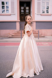 Long, princess ball gown in a soft vanilla-creme color, with a long, voluminous satin skirt, satin top with short sleeves, 3D floral embroidery and mesh details. Handmade with love. Occasions: Wedding, Birthday party, Prom, Flower girl, Eid, and other events.