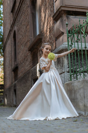 Long, princess ball gown in a soft vanilla-creme color, with a long, voluminous satin skirt, satin top with short sleeves, 3D floral embroidery and mesh details. Handmade with love. Occasions: Wedding, Birthday party, Prom, Flower girl, Eid, and other events.