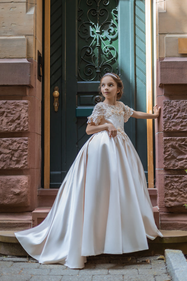 Long, princess ball gown in a soft vanilla-creme color, with a long, voluminous satin skirt, satin top with short sleeves, 3D floral embroidery and mesh details. Handmade with love. Occasions: Wedding, Birthday party, Prom, Flower girl, Eid, and other events.