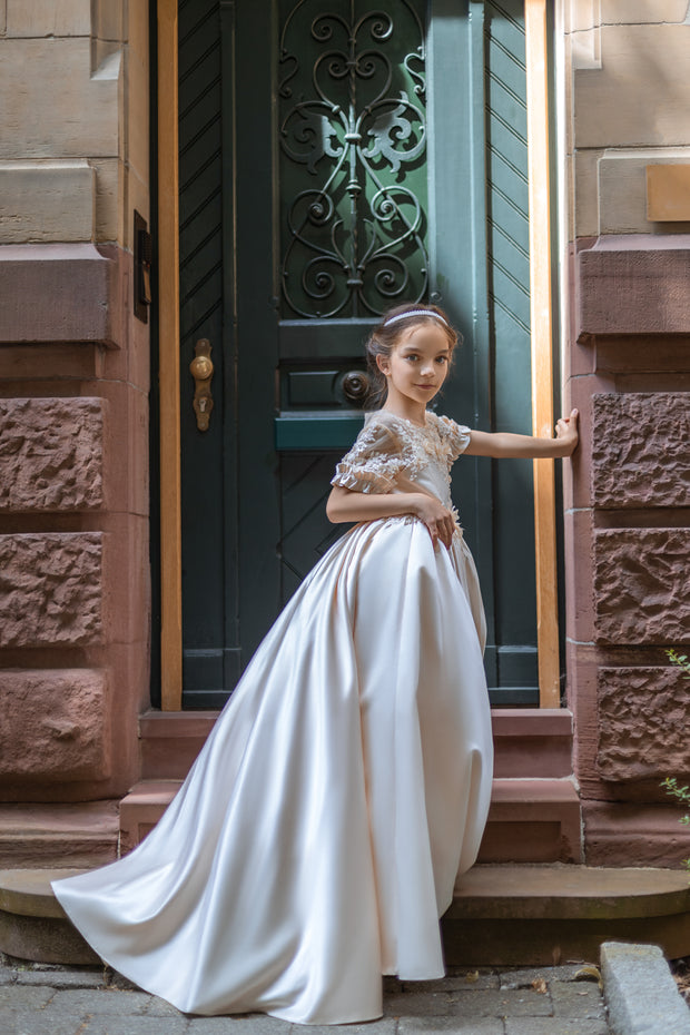 Long, princess ball gown in a soft vanilla-creme color, with a long, voluminous satin skirt, satin top with short sleeves, 3D floral embroidery and mesh details. Handmade with love. Occasions: Wedding, Birthday party, Prom, Flower girl, Eid, and other events.