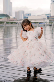 White tutu dress with floral print and puffy sleeves