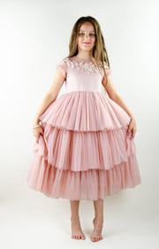 Ankle-length princess dress in a baby pink color with multi-layered tulle skirt, transparent ruffled sleeves and floral embroidery on the front and back satin bodice. Girl dress for special occasions: flower girls, weddings, birthday party, communion, Eid.