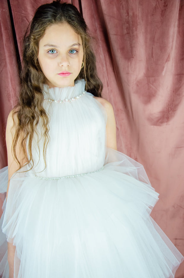 Ankle-length tulle girl dress with a multi-layered tulle skirt, tulle pleated top with a high collar and pearl embellishments along the neckline and the waistline. Princess girl dress for a girl birthday party, flower girl dress, wedding, communion.