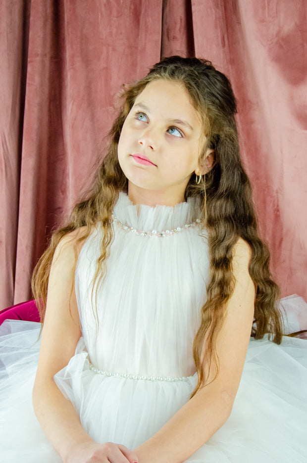 Ankle-length tulle girl dress with a multi-layered tulle skirt, tulle pleated top with a high collar and pearl embellishments along the neckline and the waistline. Princess girl dress for a girl birthday party, flower girl dress, wedding, communion.