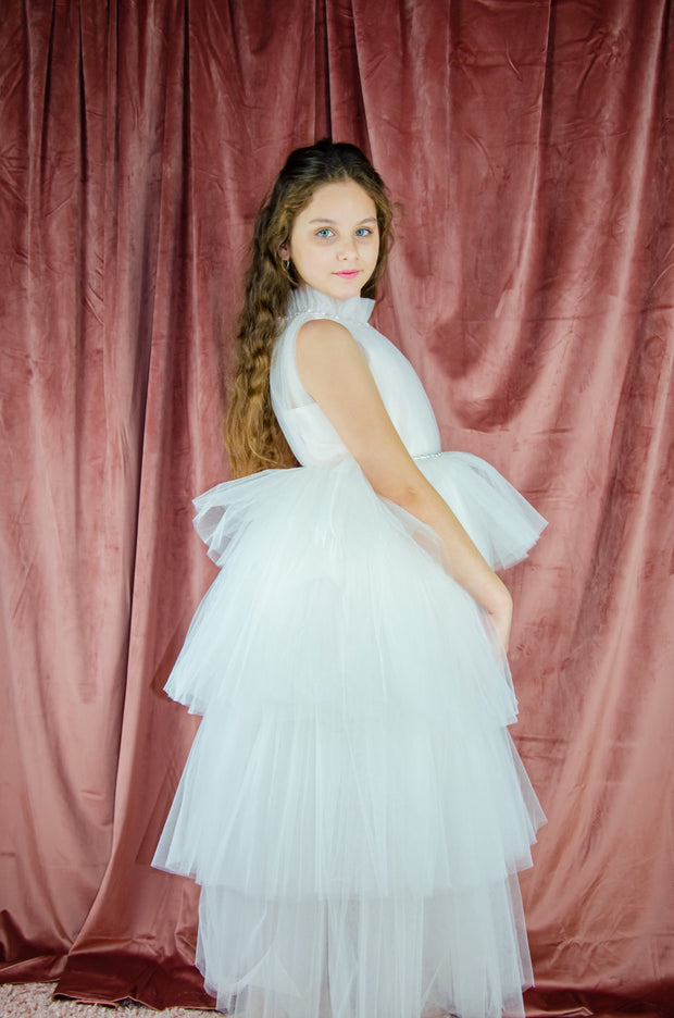 Ankle-length tulle girl dress with a multi-layered tulle skirt, tulle pleated top with a high collar and pearl embellishments along the neckline and the waistline. Princess girl dress for a girl birthday party, flower girl dress, wedding, communion.
