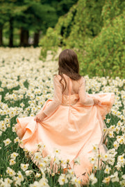 Sparkly high-low hemline girl dress with a satin skirt, satin train, long tulle sleeves and all-over rhinestone embellishments.