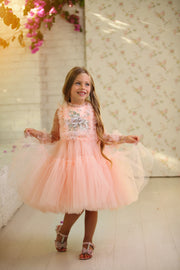 Knee-length princess girl dress with a voluminous, multi-layered tulle skirt, long, transparent tulle sleeves and satin top embroidered with pastel coloured flowers. For special occasions: Wedding, Birthday party, Prom, Flower girl, Eid, and other events.