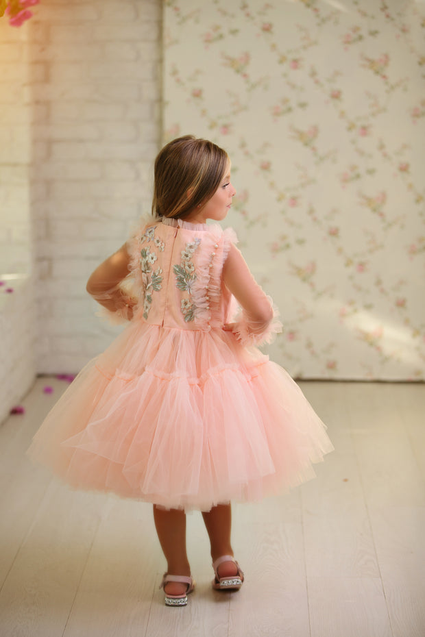 Knee-length princess girl dress with a voluminous, multi-layered tulle skirt, long, transparent tulle sleeves and satin top embroidered with pastel coloured flowers. For special occasions: Wedding, Birthday party, Prom, Flower girl, Eid, and other events.