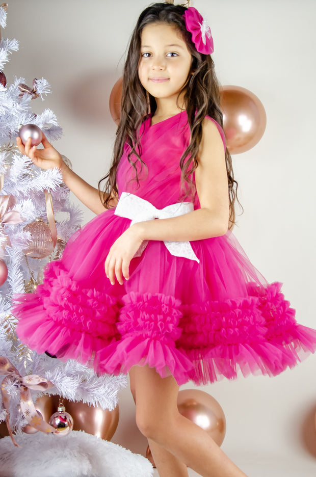 Bright pink baby girl festive dress with tulle skirt and white sequin bow. The dress is for holiday season, Christmas, New Year, weddings, Eid, birthdays, parties, flower girls and other special formal events and occasions.