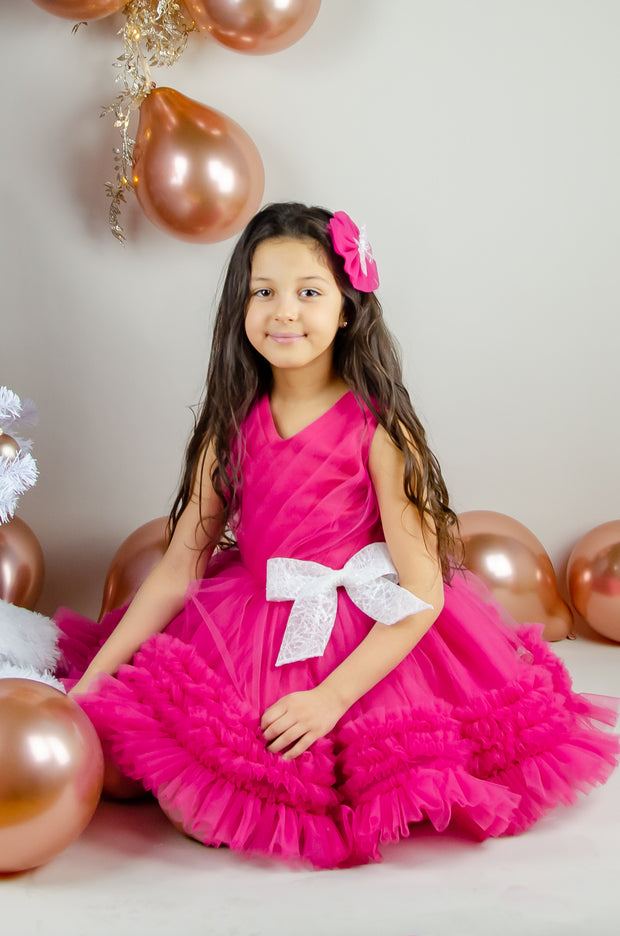 Bright pink baby girl festive dress with tulle skirt and white sequin bow. The dress is for holiday season, Christmas, New Year, weddings, Eid, birthdays, parties, flower girls and other special formal events and occasions.