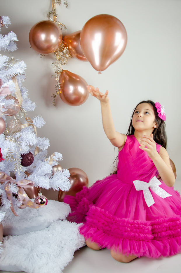 Bright pink baby girl festive dress with tulle skirt and white sequin bow. The dress is for holiday season, Christmas, New Year, weddings, Eid, birthdays, parties, flower girls and other special formal events and occasions.