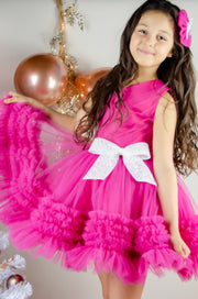 Bright pink baby girl festive dress with tulle skirt and white sequin bow. The dress is for holiday season, Christmas, New Year, weddings, Eid, birthdays, parties, flower girls and other special formal events and occasions.