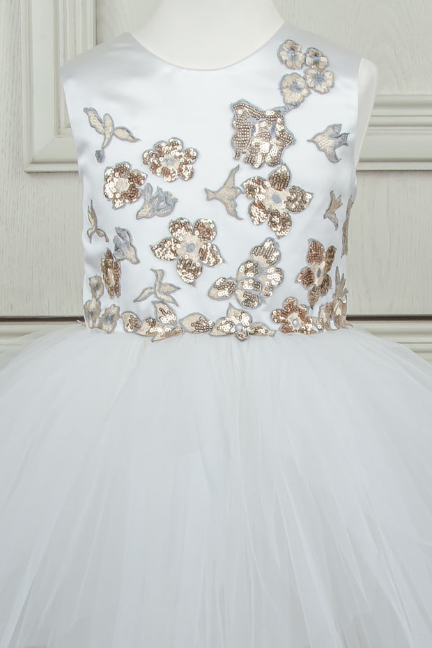 custom made personalised girl dress with an asymmetrical white tulle skirt and gold sequin embroidery in flower and birds pattern