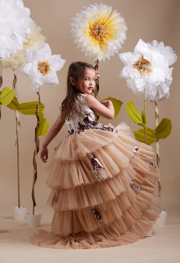 custom made, personalised girl dress in beige with a high-low hem, multi-layered tulle skirt and sequin embroidery in gold and red