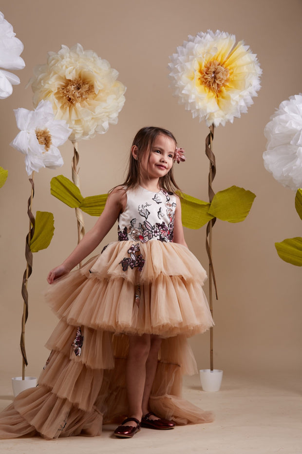 custom made, personalised girl dress in beige with a high-low hem, multi-layered tulle skirt and sequin embroidery in gold and red