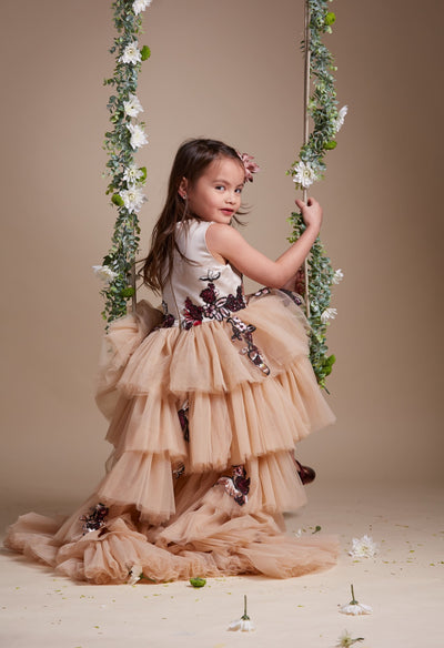 custom made, personalised girl dress in beige with a high-low hem, multi-layered tulle skirt and sequin embroidery in gold and red