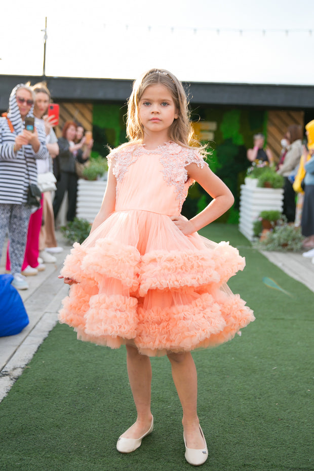 Knee-length multi-layered tulle princess girl dress in a bright salmon colour perfect your spring and summer special occasions: flower girls, weddings, birthday.