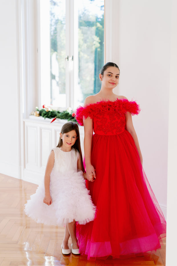 Festive, floor length princess ball gown in bright pink, with a long, voluminous tulle skirt, satin top with embroidery and off-the-shoulder neckline with tulle ruffles and feather details. For special occasions: Christmas, New Year's Eve, Wedding, Birthday party, Prom, Flower girl, Eid, and other events.