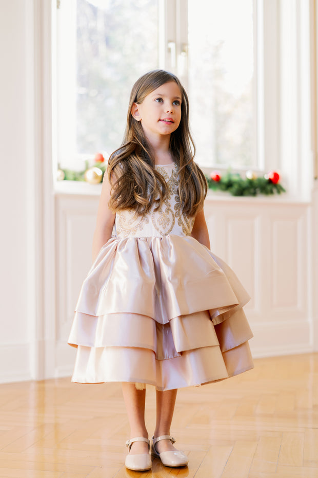Knee-length satin girl dress in a gold colour. The dress features an a-line satin skirt with tulle underskirt which gives it volume. Satin top with high neckline is accentuated with gold embroidery. For special occasions: Wedding, Birthday party, Prom, Flower girl, Eid and other events.