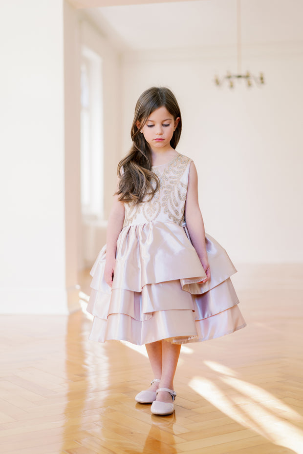 Knee-length satin girl dress in a gold colour. The dress features an a-line satin skirt with tulle underskirt which gives it volume. Satin top with high neckline is accentuated with gold embroidery. For special occasions: Wedding, Birthday party, Prom, Flower girl, Eid and other events.