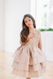 Knee-length satin girl dress in a gold colour. The dress features an a-line satin skirt with tulle underskirt which gives it volume. Satin top with high neckline is accentuated with gold embroidery. For special occasions: Wedding, Birthday party, Prom, Flower girl, Eid and other events.