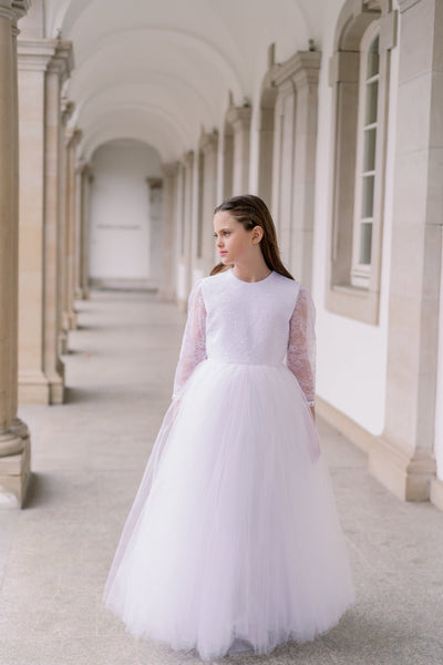 Long, a-line tulle first communion dress in white with long tulle skirt, floral lace top, high neckline and long transparent lace sleeves. Handmade with love. Occasions: First Communion, Flower girl, Wedding, Birthday party, and other events. 