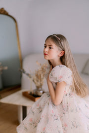 Knee-length voluminous girls' tutu dress in white with all-over soft floral print and short puffy sleeves. Handmade with love. For special occasions: Wedding, Birthday party, Prom, Flower girl, Eid, and other events.