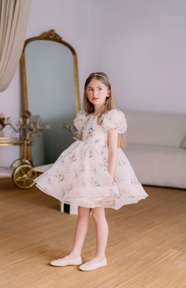 Knee-length voluminous girls' tutu dress in white with all-over soft floral print and short puffy sleeves. Handmade with love. For special occasions: Wedding, Birthday party, Prom, Flower girl, Eid, and other events.