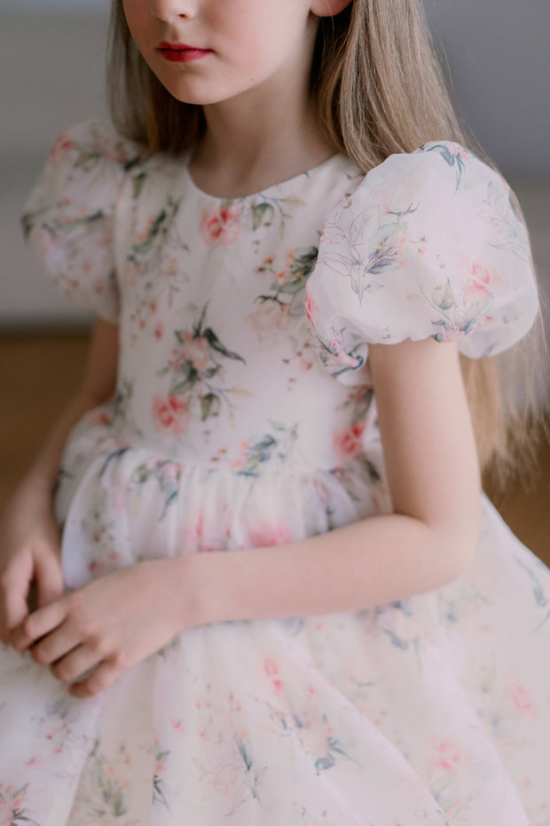 Knee-length voluminous girls' tutu dress in white with all-over soft floral print and short puffy sleeves. Handmade with love. For special occasions: Wedding, Birthday party, Prom, Flower girl, Eid, and other events.