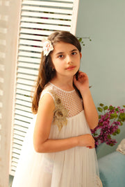 white flower girl dress decorated with floral embellishment