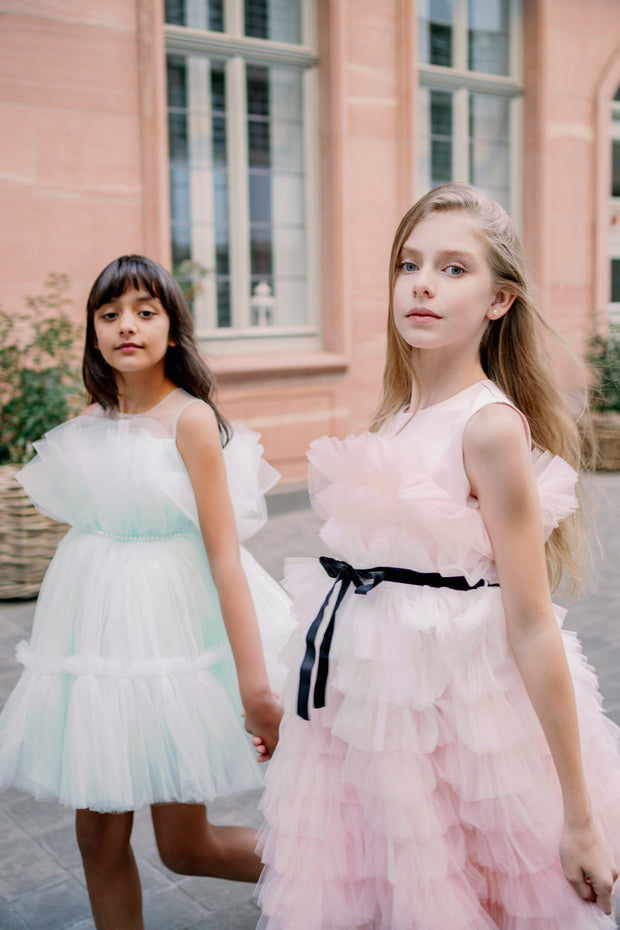 Midi length princess girl dress with ombre effect in white and pink with a ruffled tulle skirt and contrasting black ribbon at the waistline. For special occasions: Wedding, Birthday party, Prom, Flower girl, Eid, and other events.