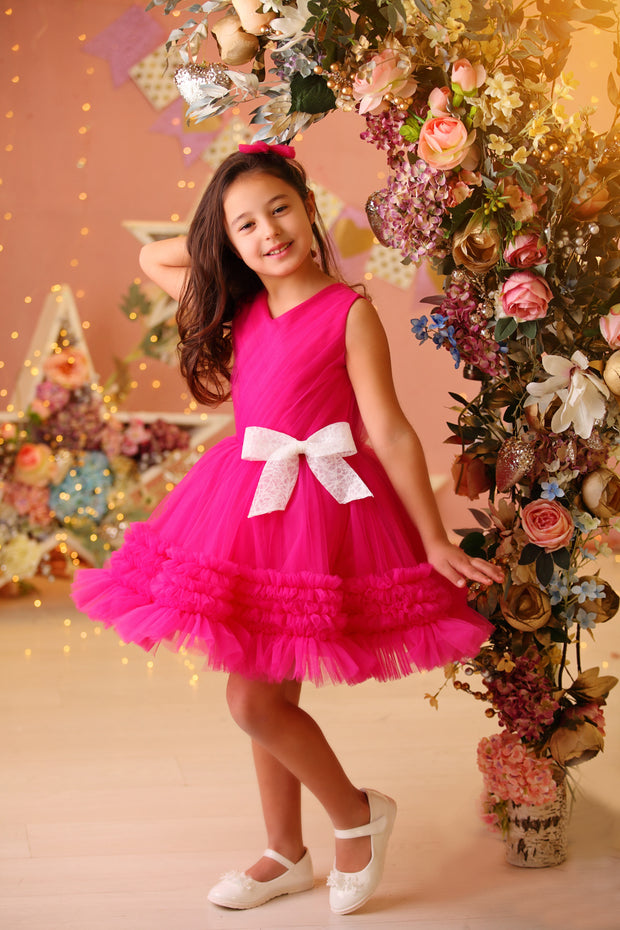 Bright pink baby girl festive dress with tulle skirt and white sequin bow. The dress is for holiday season, Christmas, New Year, weddings, Eid, birthdays, parties, flower girls and other special formal events and occasions.