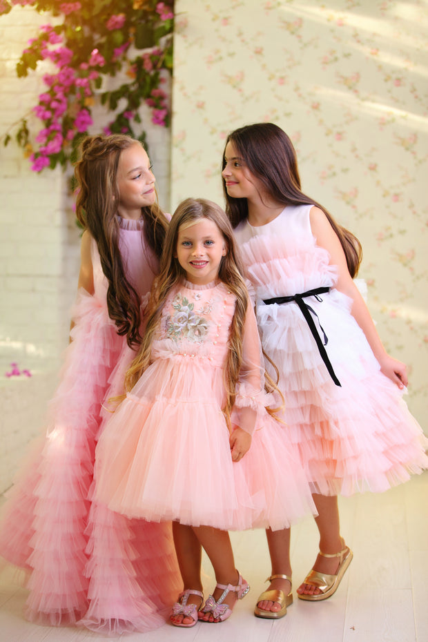 Knee-length princess girl dress with a voluminous, multi-layered tulle skirt, long, transparent tulle sleeves and satin top embroidered with pastel coloured flowers. For special occasions: Wedding, Birthday party, Prom, Flower girl, Eid, and other events.