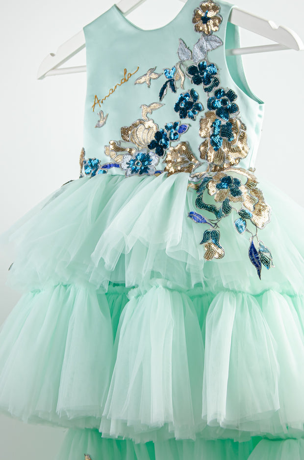 custom made personalised girl tulle dress with high-low hemline, mint tulle skirt and gold and blue sequin embellishments