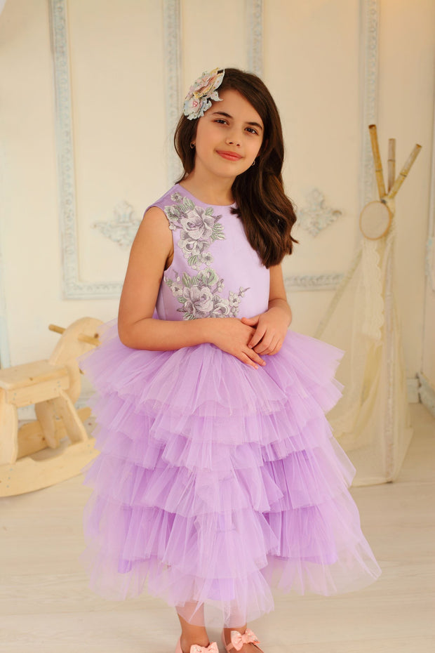 little girl dresses up in purple dress for special occasion