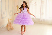 little girl dresses up in purple dress for special occasion