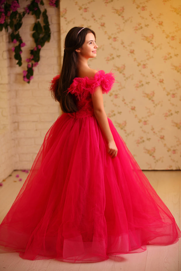 Floor length princess ball gown in bright pink, with a long, voluminous tulle skirt, satin top with embroidery and off-the-shoulder neckline with tulle ruffles and feather details. For special occasions: Wedding, Birthday party, Prom, Flower girl, Eid, and other events.